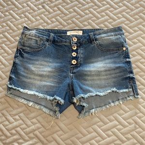 Distressed denim button fly exposed shorts.  Size 9.